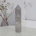 Rutilated quartz obelisk tower with gray crystal body and dark needle inclusions