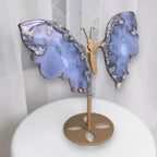 Blue agate butterfly sculpture with gold stand and round base, angled view