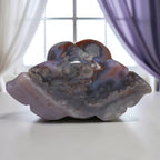 Rose-shaped agate carving with layered petals in gray-blue and reddish-brown accents