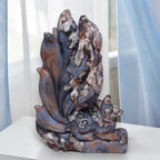 Blue and tan nine-tailed fox carving with carved paws and flowing tail ridges