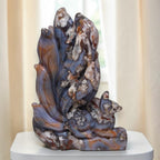 Standing nine-tailed fox carving in blue, cream, and brown stone with textured swirls