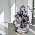 White and blue purple agate fox sculpture on a pedestal with layered tail formation