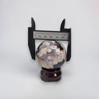 Decorative sphere with a ruler for scale on a white background