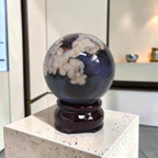 Decorative sphere with a dark blue base on a white pedestal