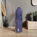 Purple agate crystal on a wooden surface with a neutral background