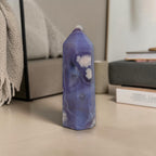 Decorative candle with a geometric design on a floor in a living room setting