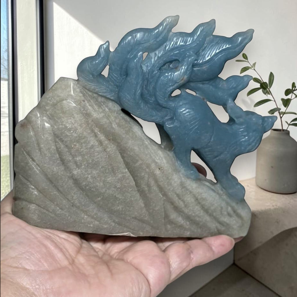 Blue trolleite nine tailed fox crystal carving lifestyle display with natural light