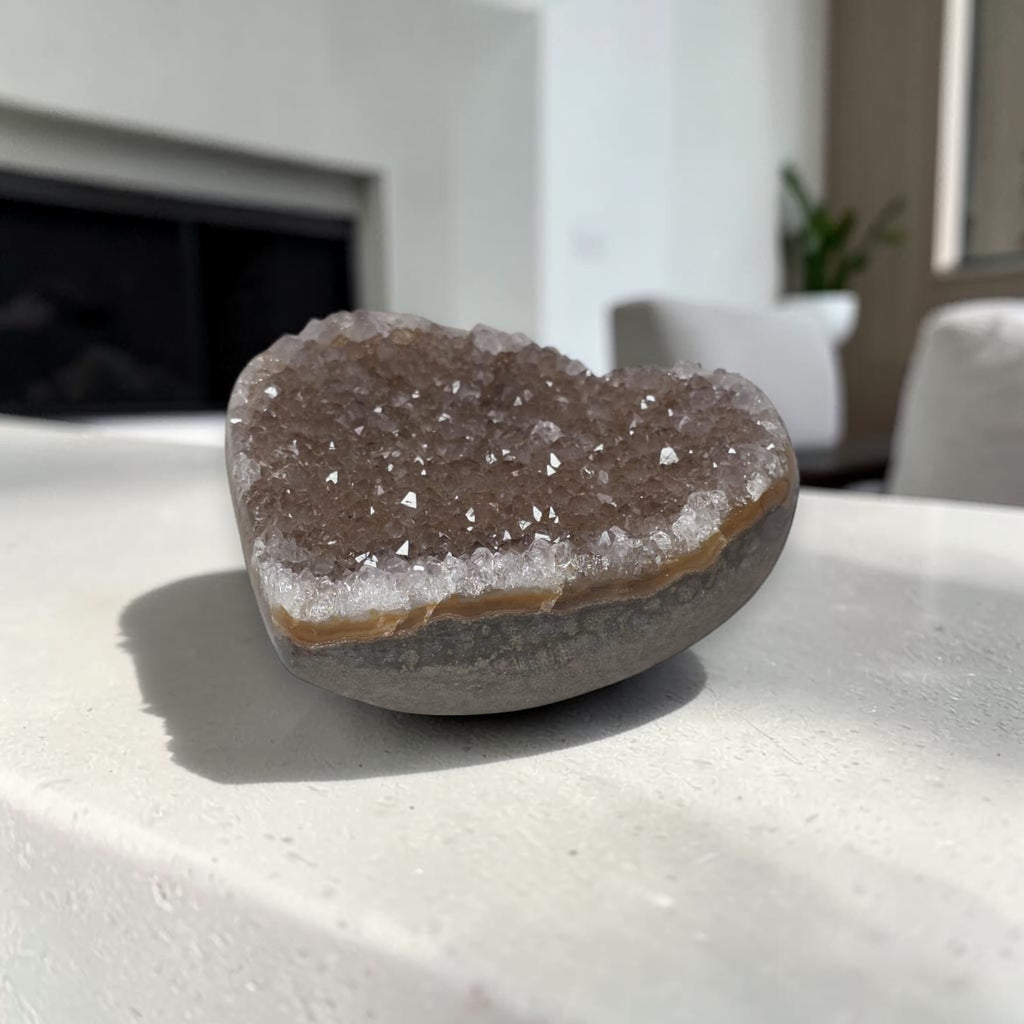 Geode crystal on a white surface with a blurred outdoor background