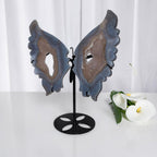 Blue agate butterfly wings crystal sculpture on black stand, centered