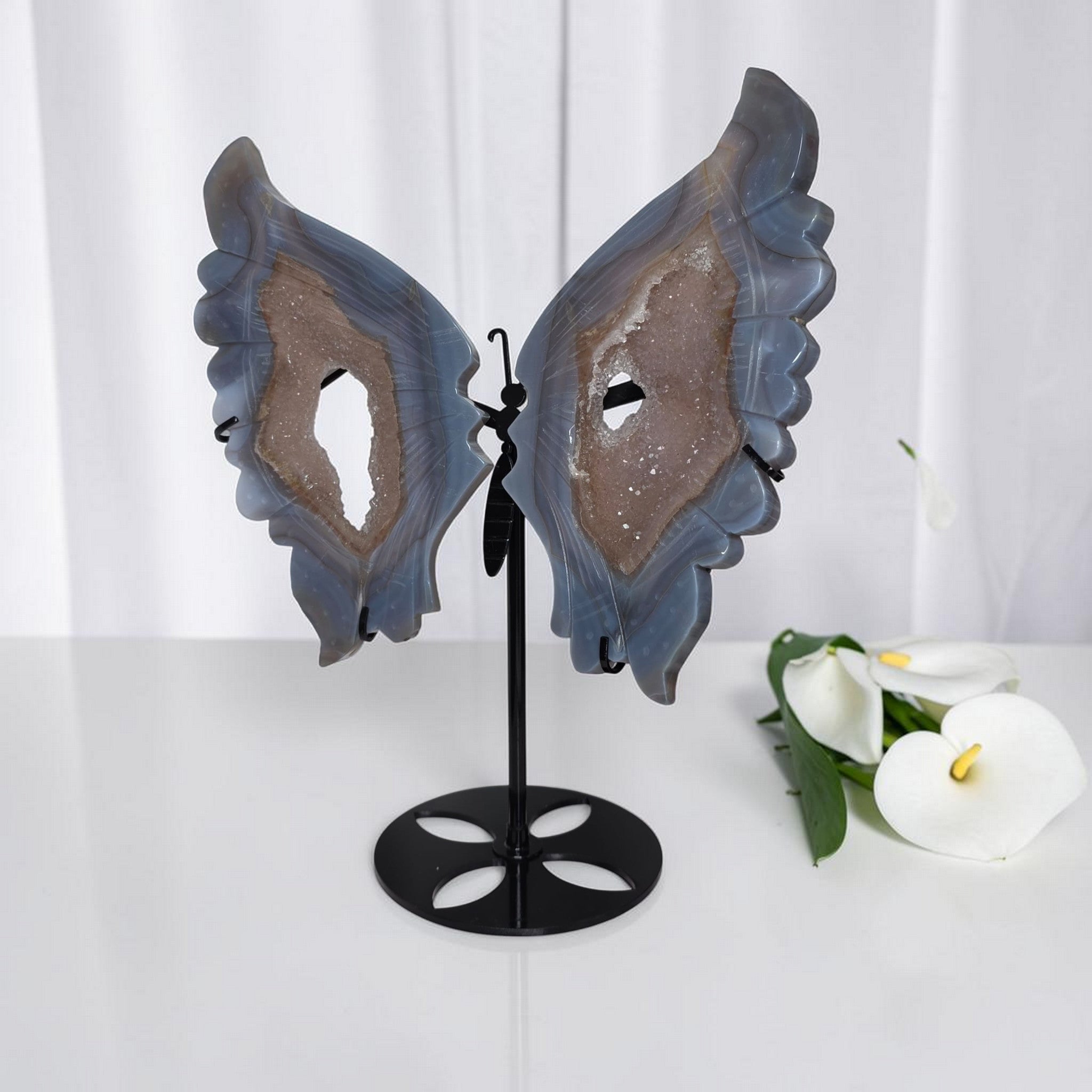 Blue agate butterfly wings crystal sculpture on black stand, centered