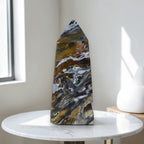 Polished ocean jasper obelisk with white veining, dark blue-gray and gold bands