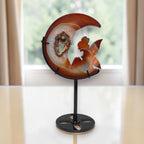 Front view moon crystal carving with fairy figures and druzy geode, on black base stand