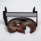Amber and brown moon crystal carving with fairy figures and druzy geode, on black stand