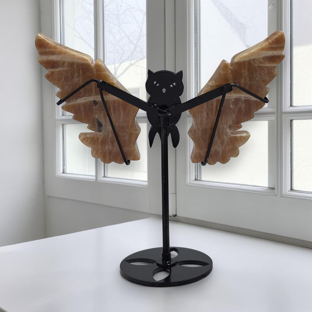 Honey Calcite owl wings sculpture displayed on black stand