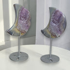 Pair of crescent moon purple druzy agate geodes on silver stands, angled view