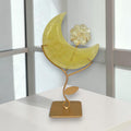 Citrine crescent moon and flower display in natural light