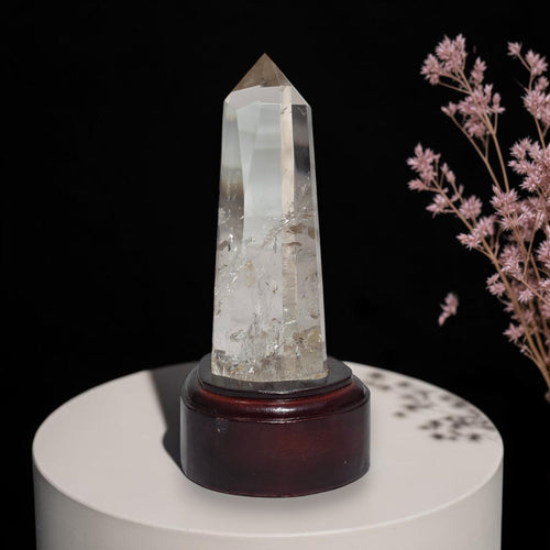 Clear quartz crystal point tower on dark stand