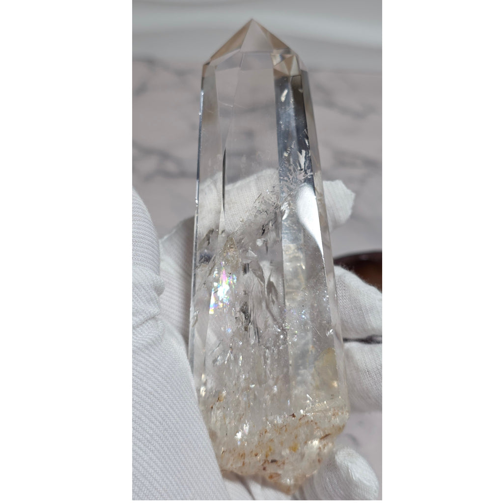 Clear quartz obelisk tower showing internal veils and fractures