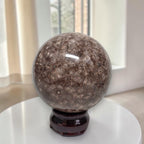 Coral jasper sphere 80mm on dark stand, speckled brown and gray veining