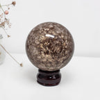 Coral jasper sphere 80mm on dark stand, dark brown mottled surface with flecks