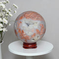 Agate sphere on stand, blue-gray with copper-orange veining and cloudy swirls