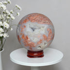 Agate sphere on stand, blue-gray with copper-orange veining and cloudy swirls