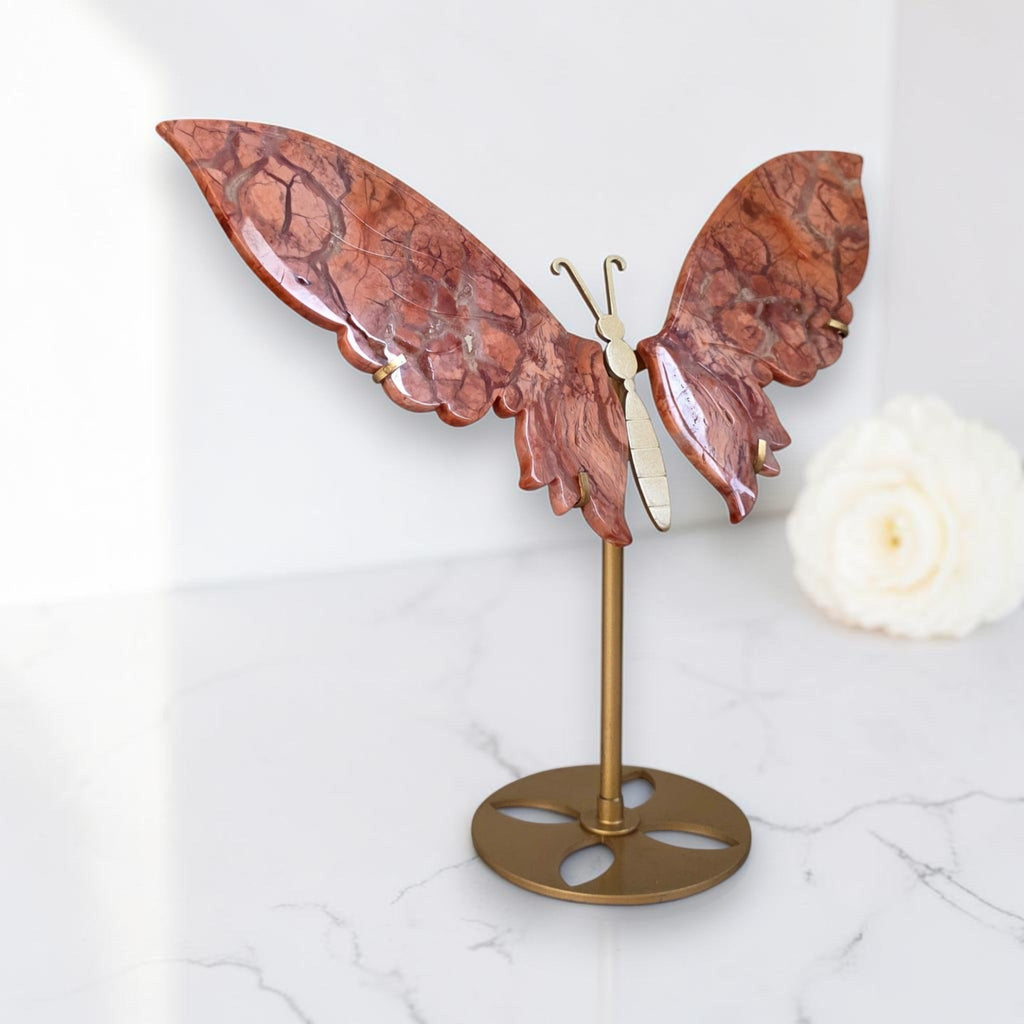 Cotton Candy Agate butterfly sculpture on antique gold stand, angle view