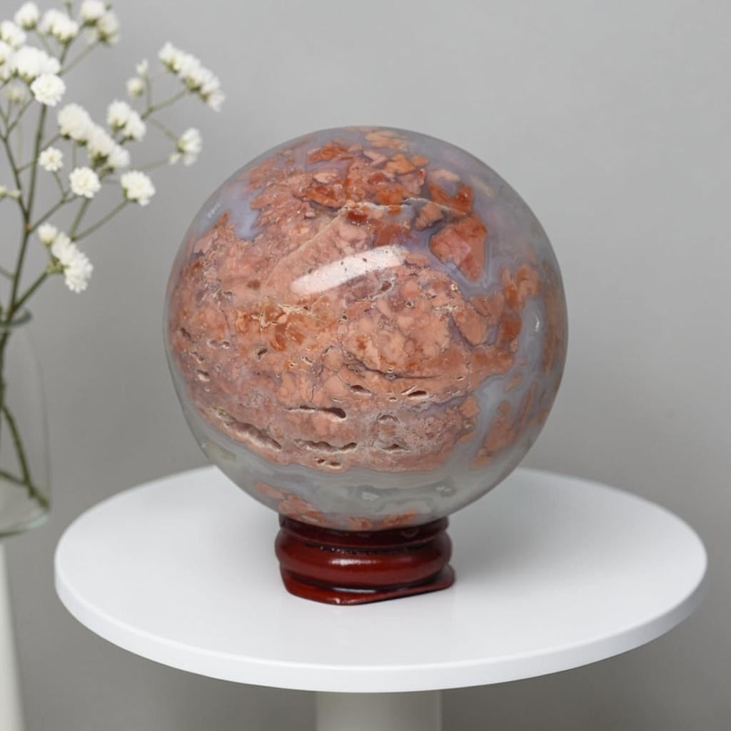 Agate sphere on stand, blue-gray with rich orange-brown inclusions