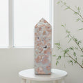 Pink and cream patterns on Cotton Candy Agate tower held in a gloved hand