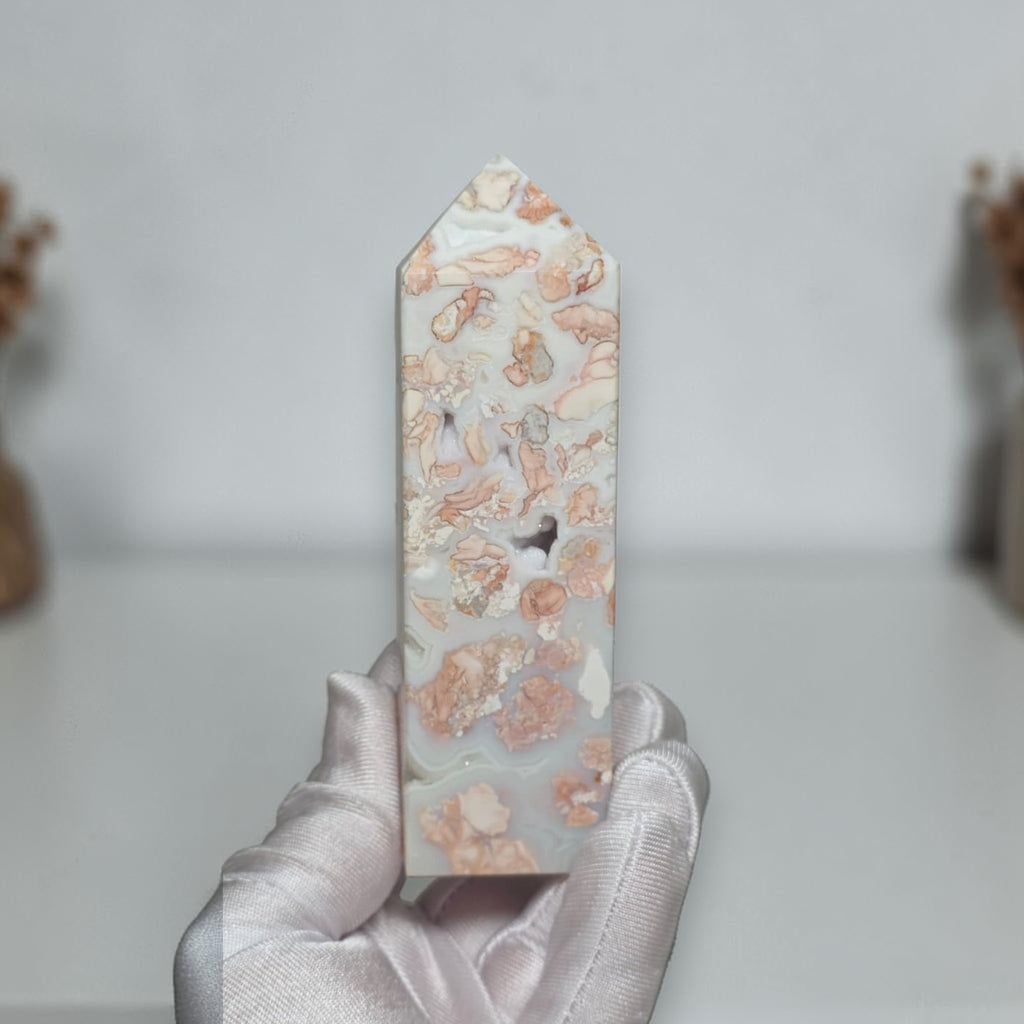 Pink Flower Agate Tower shown in hand for scale