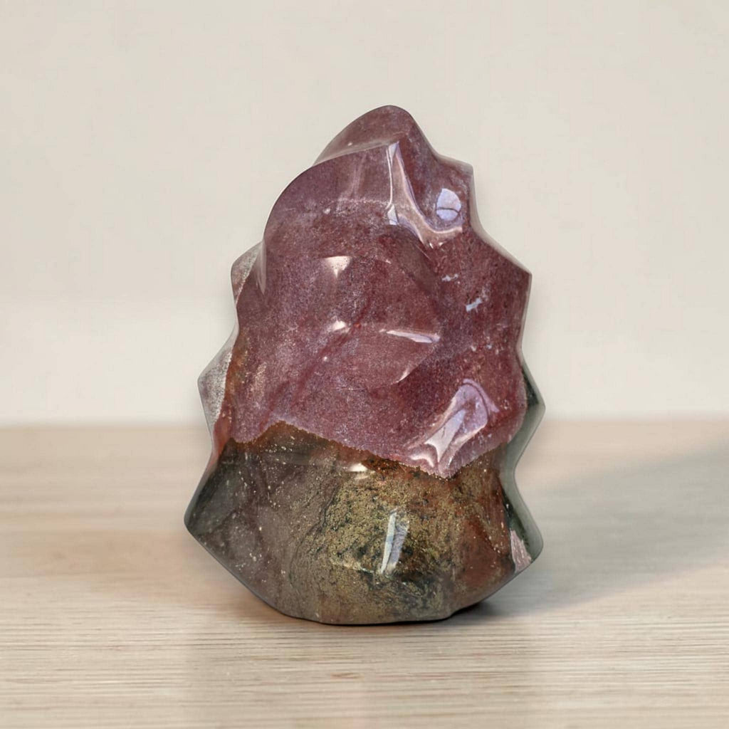 Flame-shaped jasper crystal sculpture with faceted purple-red top and dark green bottom
