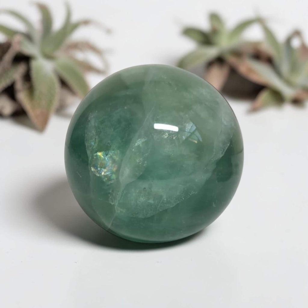 Green fluorite sphere with glossy surface and internal inclusions