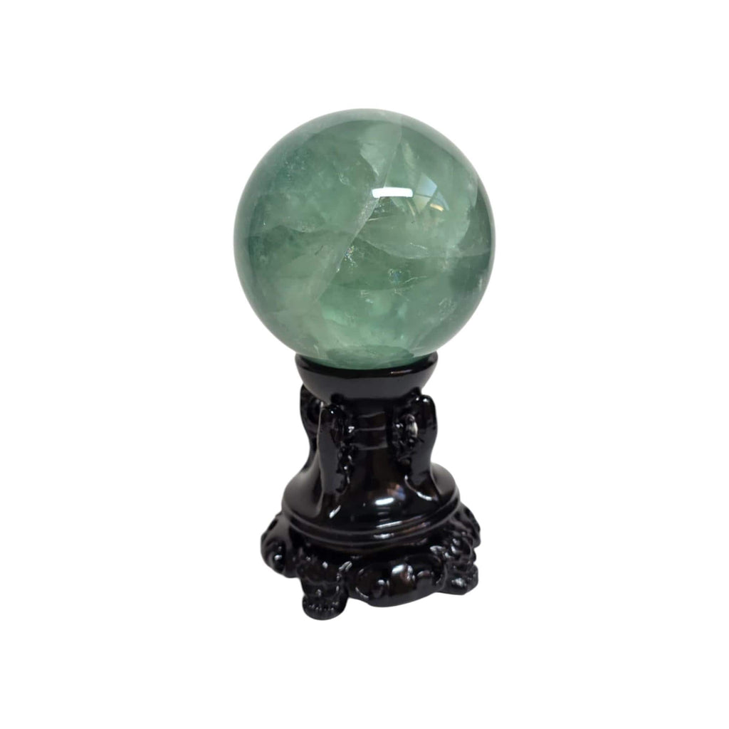 Green fluorite sphere on dark ornate pedestal, rounded glossy stone
