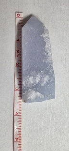 Blue-violet crystal obelisk with druzy texture and tan mineral inclusions