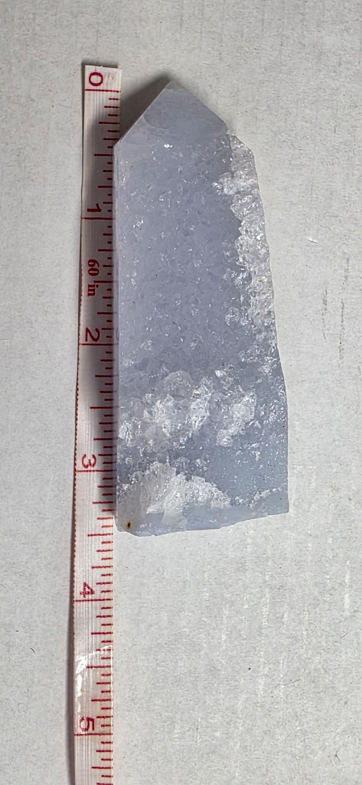 Blue-violet crystal obelisk with druzy texture and tan mineral inclusions