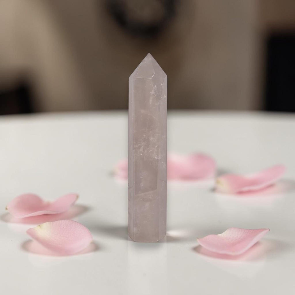 Rose quartz crystal tower, translucent pale pink with beveled pointed top