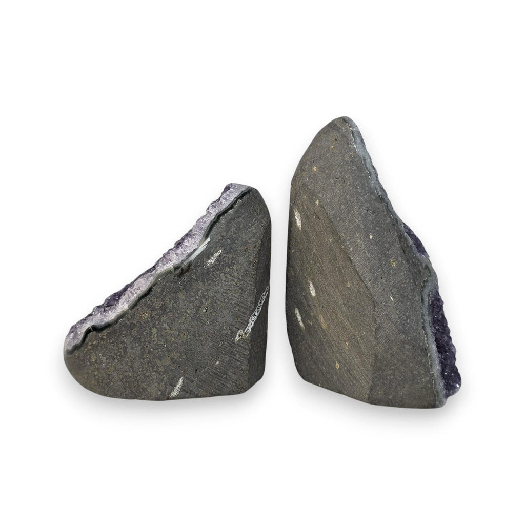 Two amethyst quartz crystal pieces with dark backs and faint pale lines, shown side-by-side
