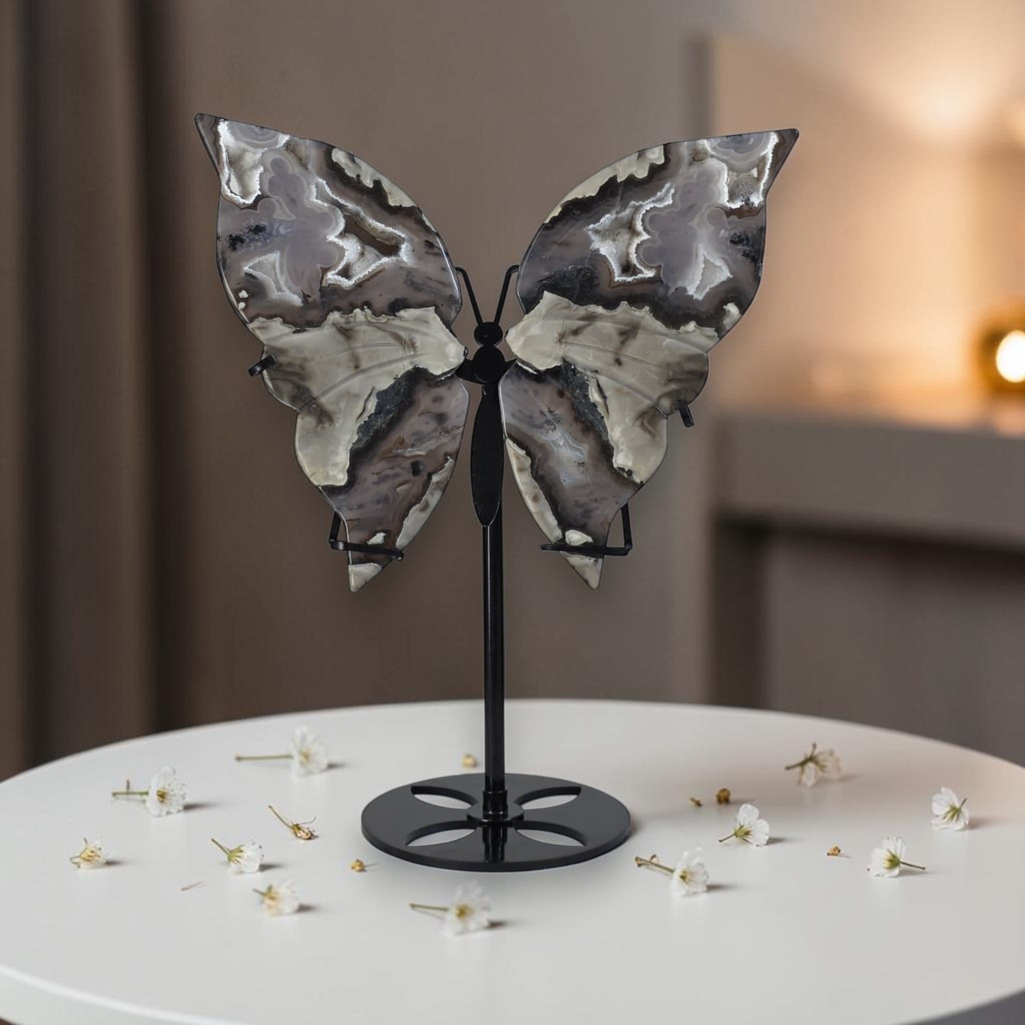 Decorative butterfly sculpture on a stand with a blurred background