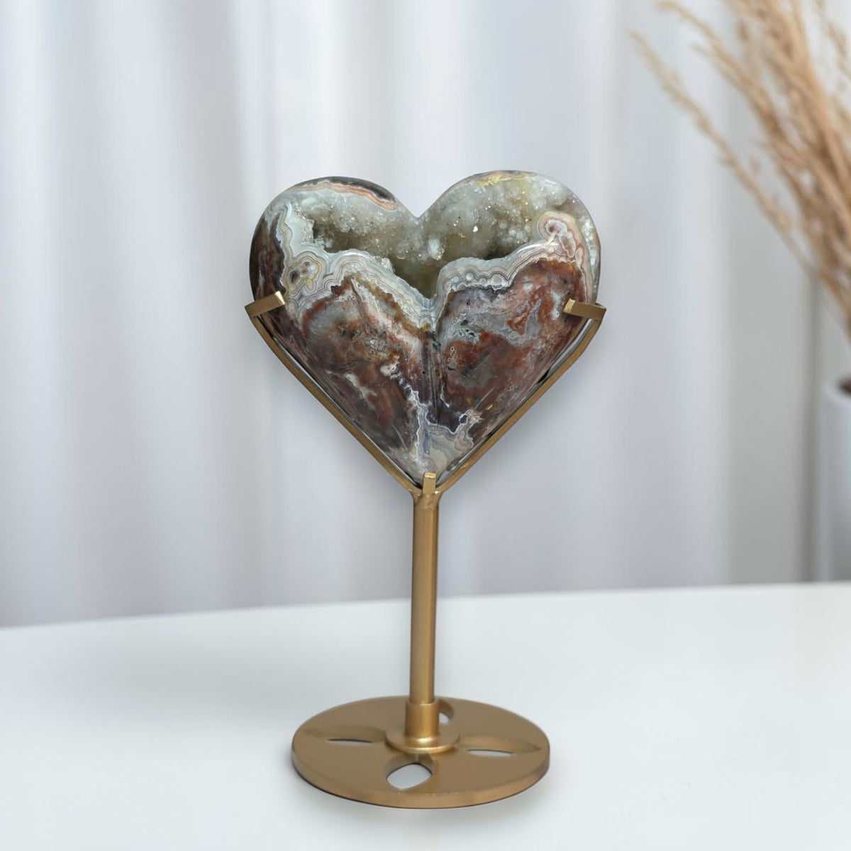 Mexican crazy lace agate heart with sparkling druzy on a gold tone stand