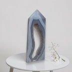Geometric crystal sculpture on a white table with a minimal background