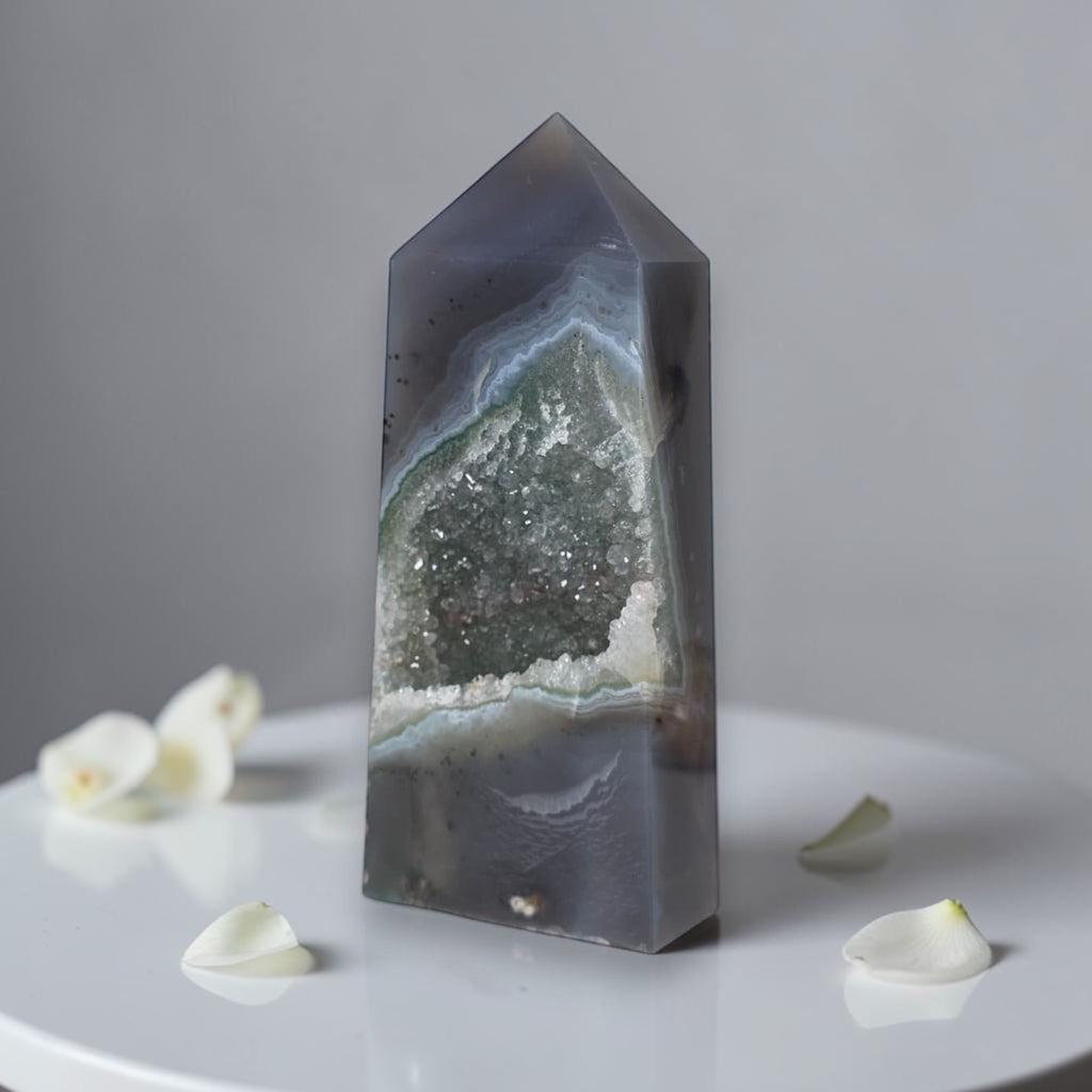 Geode crystal on a white surface with a gray background