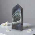 Geode crystal on a white surface with a gray background