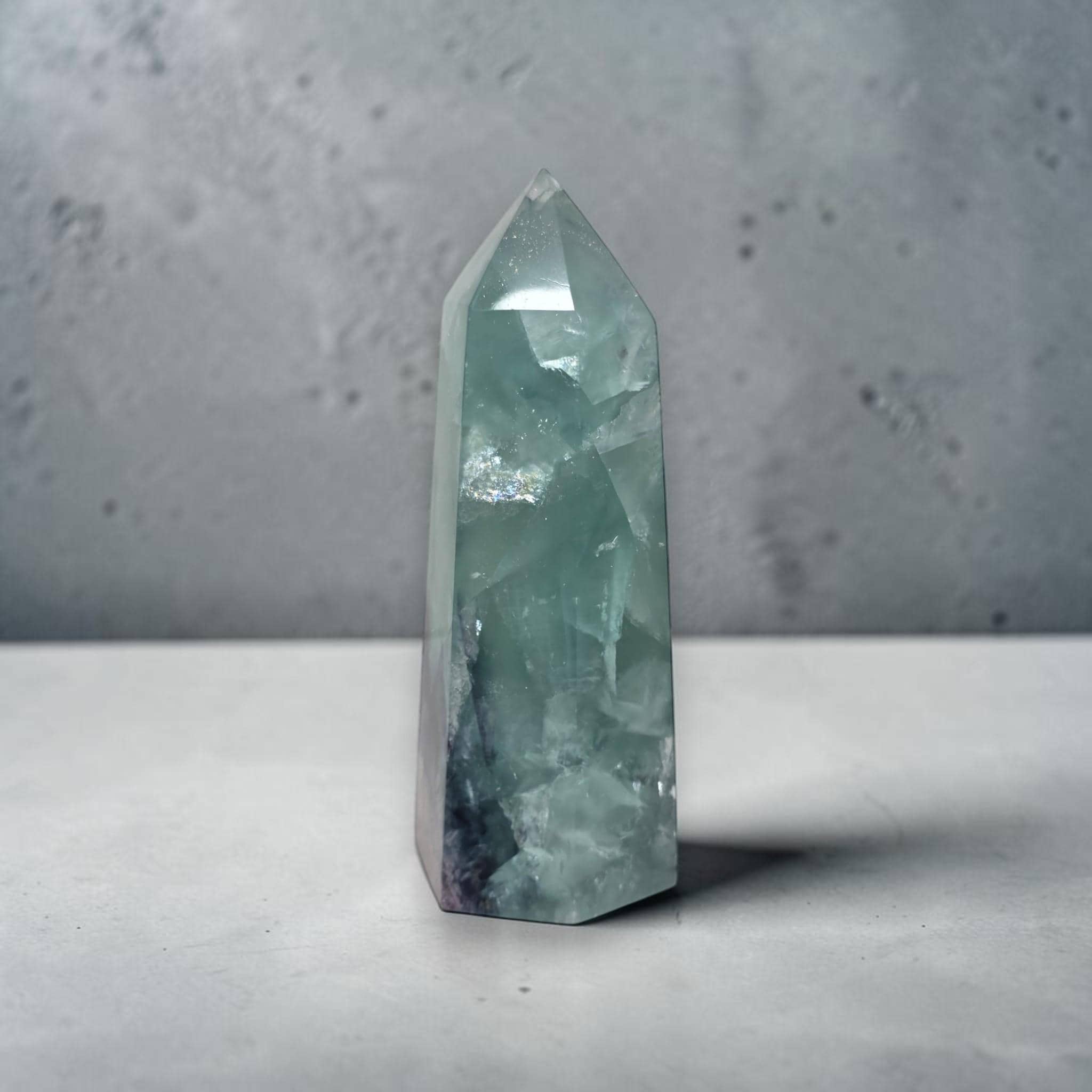 Fluorite crystal tower with pointed top, seafoam green facets with blue-gray base