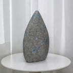 Teardrop polished stone, gray with blue spots, pointed top and smooth base