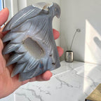 Eagle head crystal sculpture in glossy gray-blue stone with detailed feathers and highlights