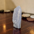 Light blue druzy crystal obelisk with pointed top and uneven faceted edges