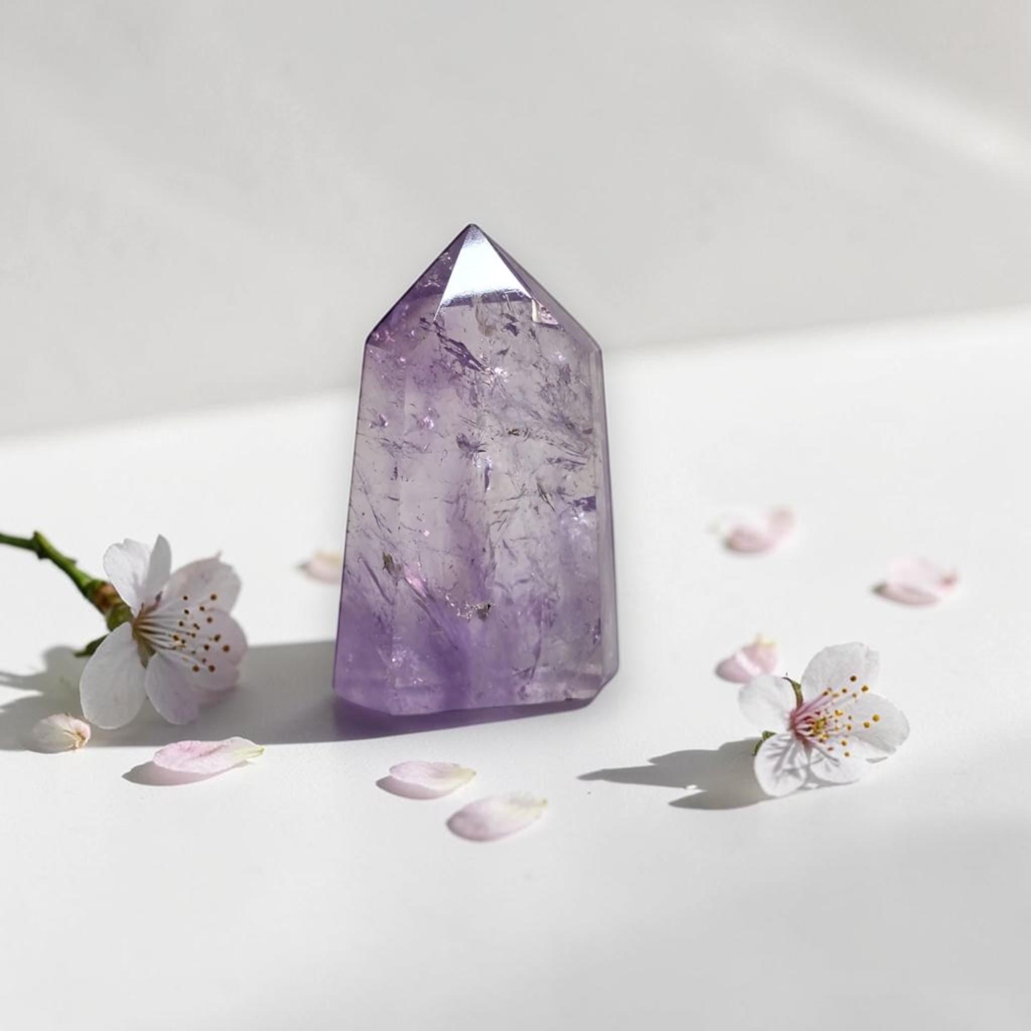 Amethyst quartz point tower, natural purple with faceted top and polished sides.