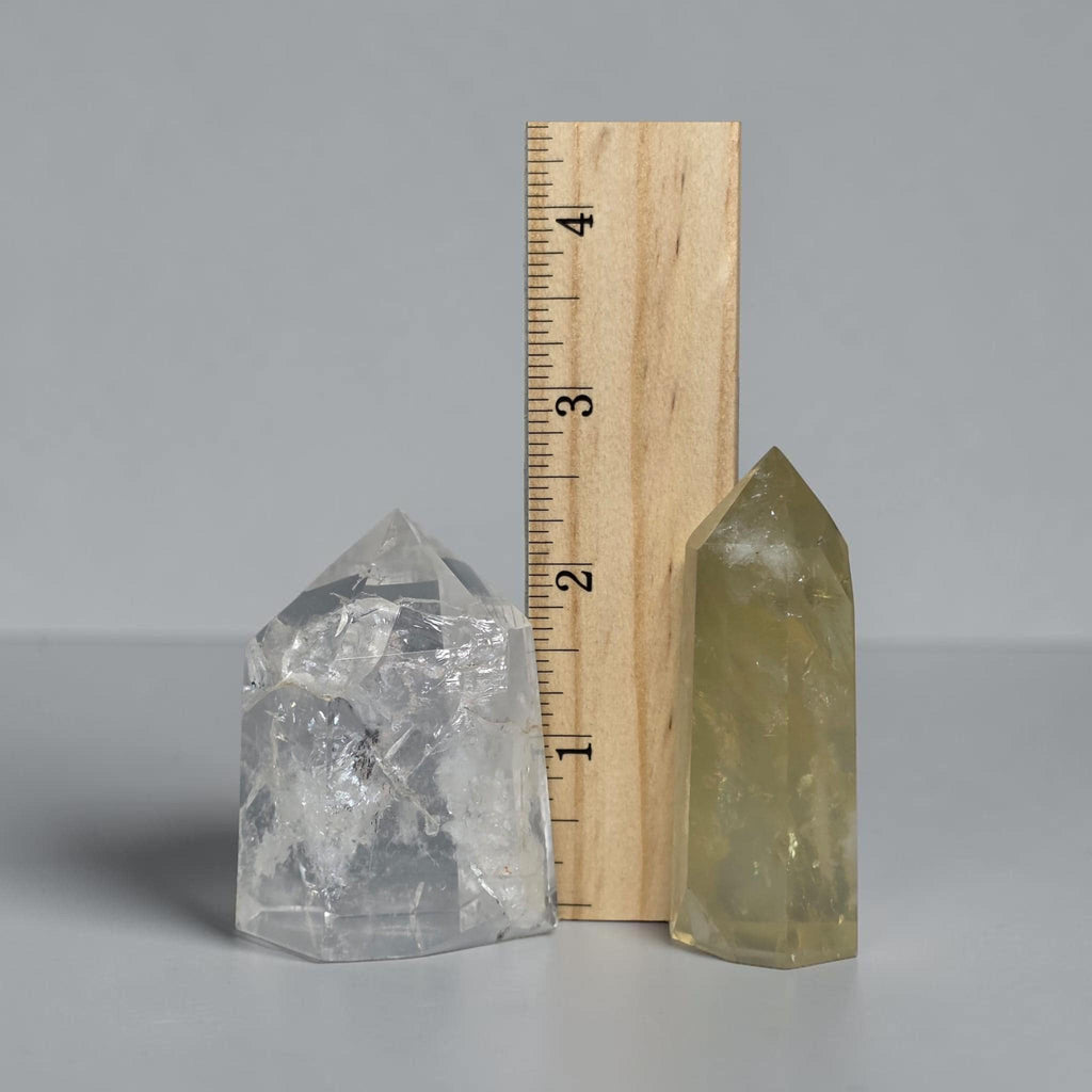 Quartz tower pair with ruler for scale, clear and pale yellow points
