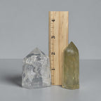 Quartz tower pair with ruler for scale, clear and pale yellow points