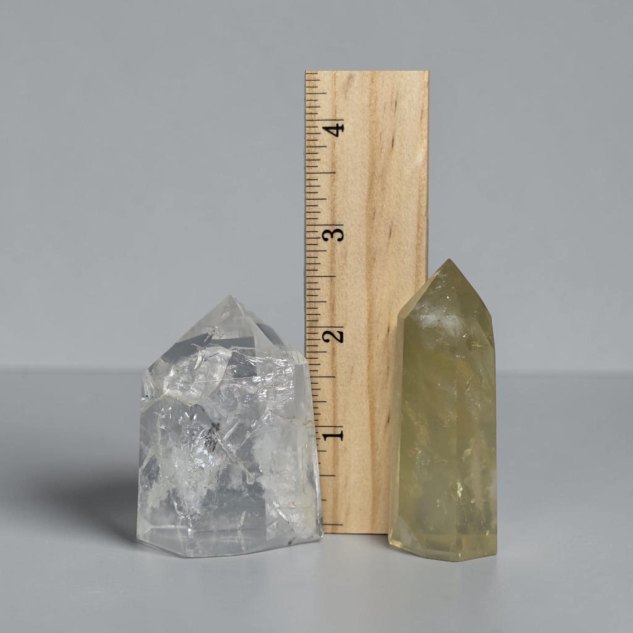 Quartz tower pair with ruler for scale, clear and pale yellow points